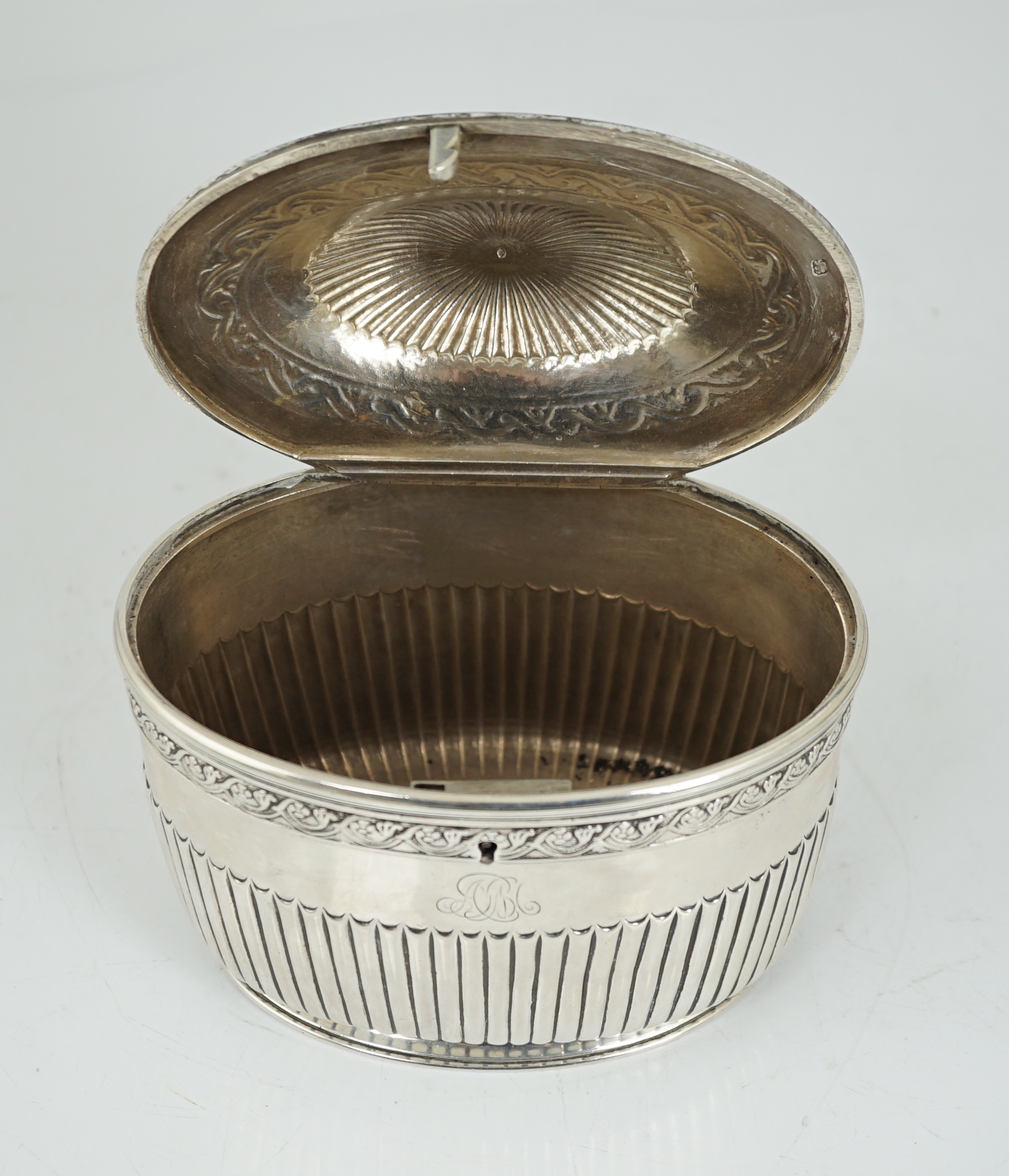 A George III demi fluted silver oval tea caddy by Andrew Fogelberg & Stephen Gilbert